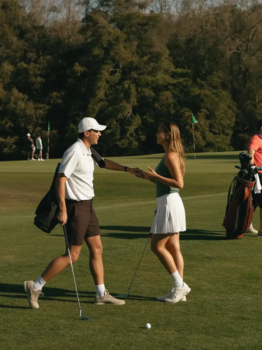 Two golfers greeting one another on the course